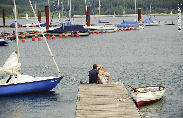 Ein Paar genießt die Zeit an einem Steg des Segelhafens im Seezentrum Ramsberg am Großen Brombachsee